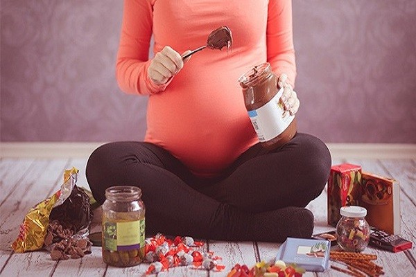 Mamma in gravidanza che mangia ogni tipo di dolciume
Voglie in gravidanza: tutti i rischi